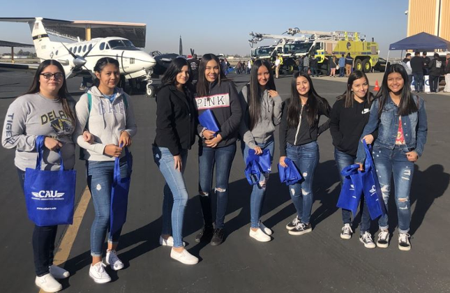  Students in front of an airplane.